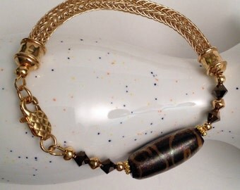 Natural brass (gold) ladies viking knit with lampwork focal