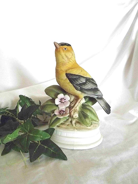 yellow ceramic bird figurine