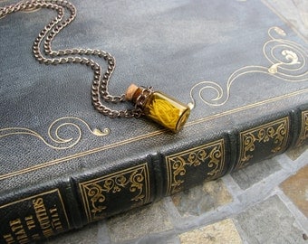Amber Colored Glass Vial with Mouse Ribs on a Chain Necklace
