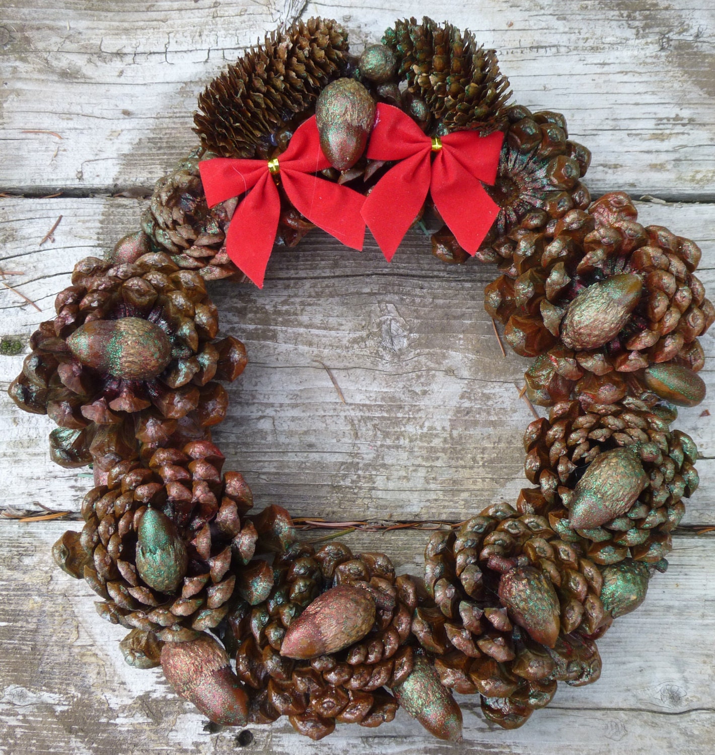 Pinecone Rosette Holiday Wreath with acorns painted with red and green glitter spray.