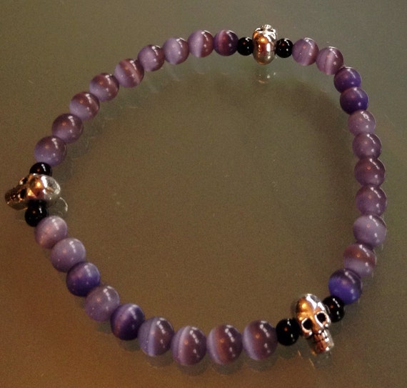 Items similar to Purple Beaded bracelet with Skulls on Etsy