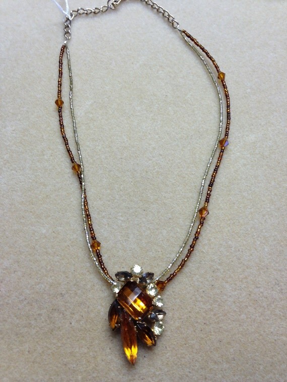 Vintage 1940s amber brooch on beaded necklace.