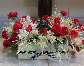 Black and White Spotted Hen In Raffia Nest, Pam's DeZines Floral Arrangement With Red Carnations And White Lily Of The Valley (Item 133)