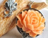 Music box locket, round locket with music box inside, in silver with peach rose and silver filigree accent, permanently sealed