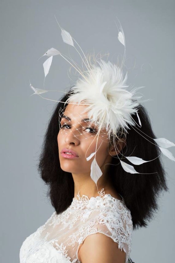 Items similar to Ivory feather bridal/wedding headpiece with veil on Etsy