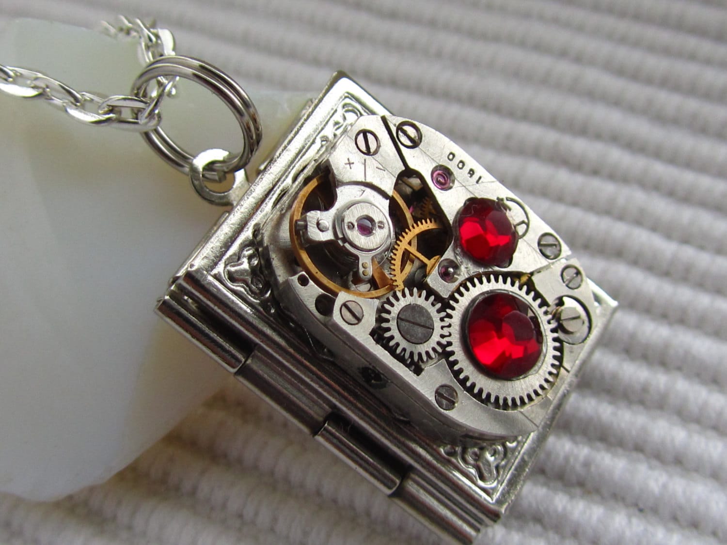 Steampunk book locket necklace with vintage watch  movement and  Ruby Red  Swarovski crystals