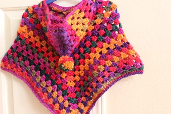 Crochet Hooded Poncho with a pom pom in Vibrant colors made with Soy Silk yarn.