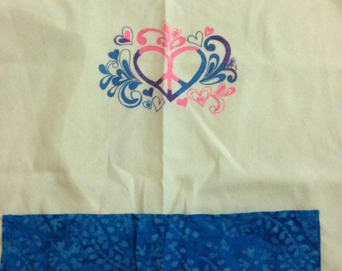 Full Adult Canvas Apron that ties in the back. Two blue patterned pockets in front, Heart/flower/peace sign design painted on front.