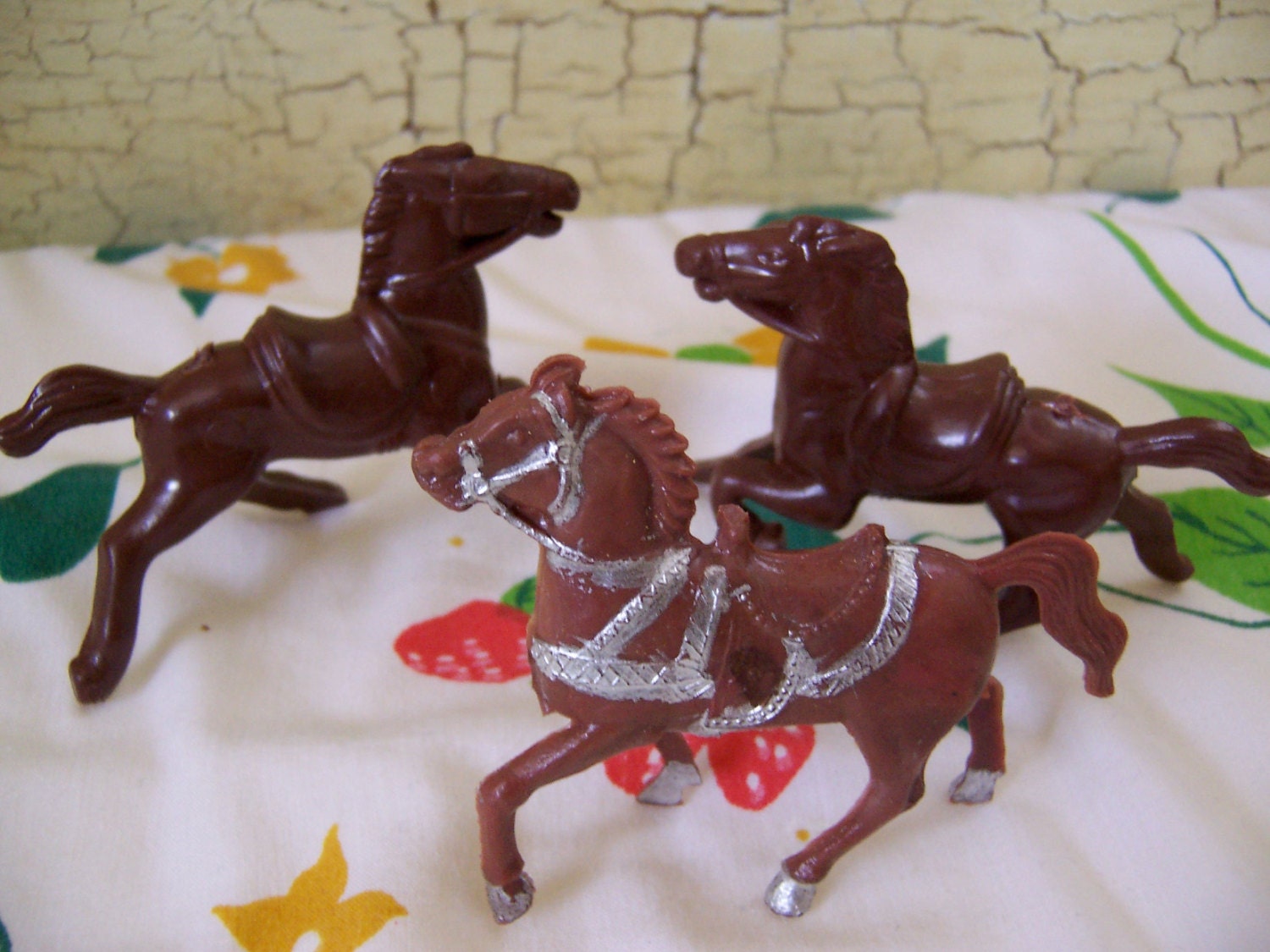 three small vintage plastic toy horses