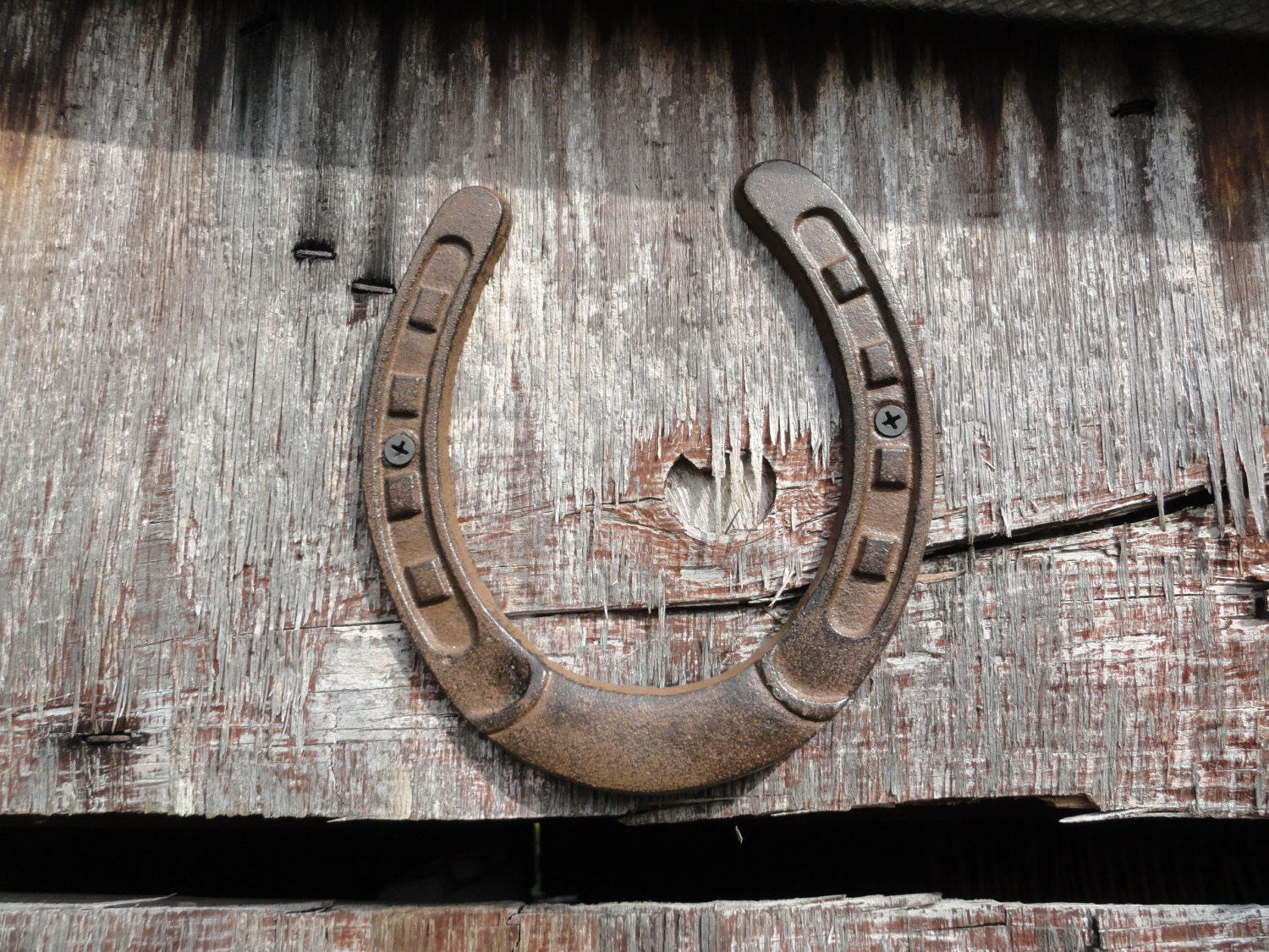 Cast Iron Horse Shoe Lucky above the barn door western cowboy