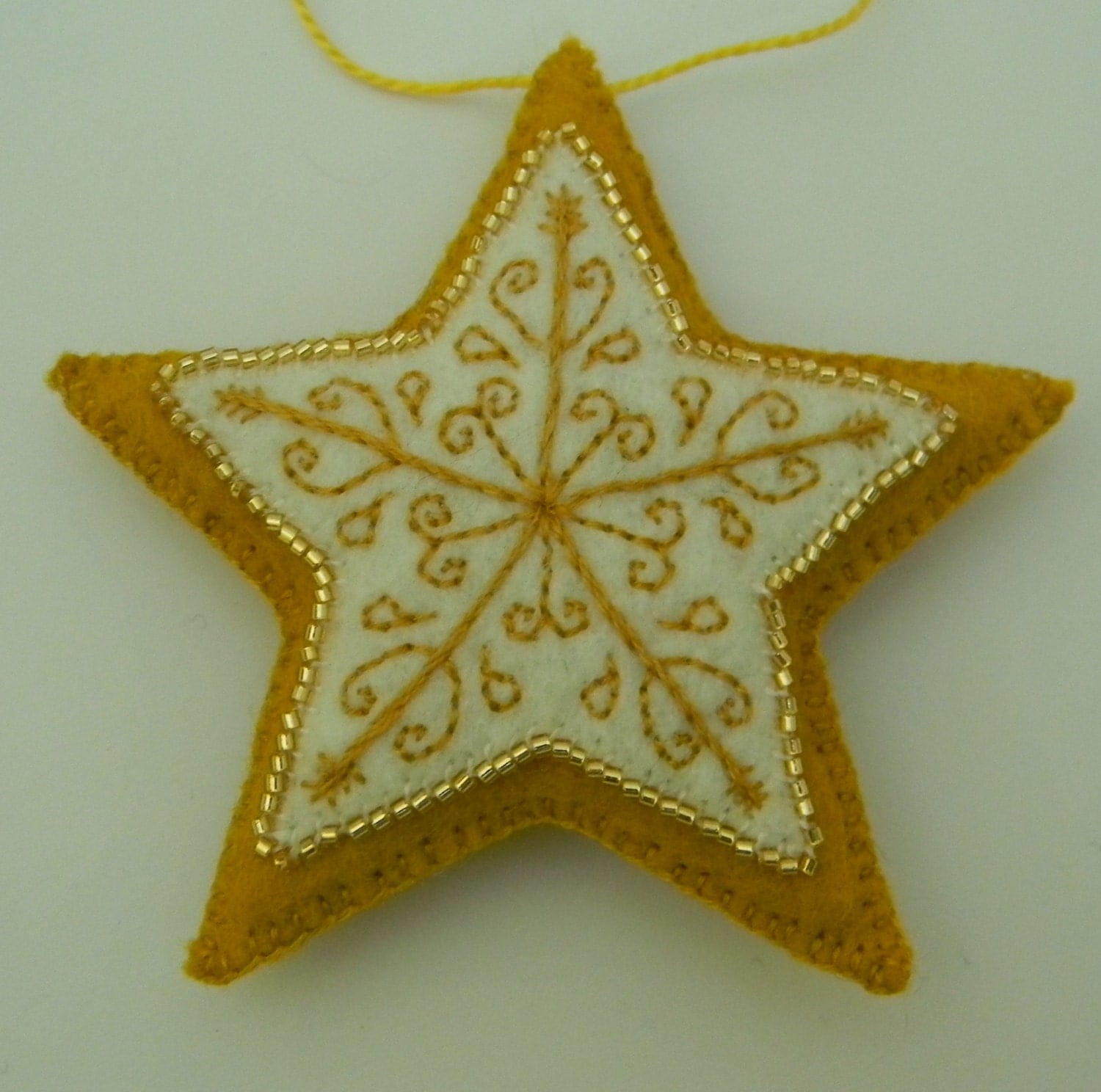 gold with white embroidered felt star ornament