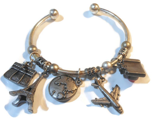 FREE SHIPPING Avon travel charm cuff bracelet marked nr silver plate with pewter charms - camera, plane, globe, Eiffel Tower, briefcase