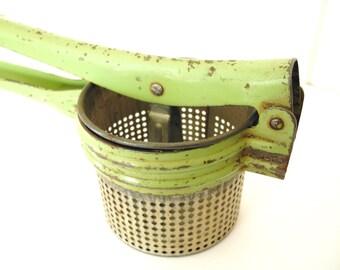 Vintage green potato ricer by Handy Things of Ludington, Michigan