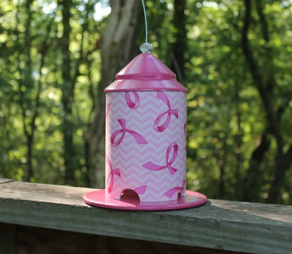 pink ribbon on white wrapped bird feeder by bird by pink ribbon on white wrapped bird feeder by bird by