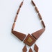 Vintage Modernist teak wood necklace 1950s. Handcrafted polished wood and brass pendant. Danish Mid Century Modern jewelry.