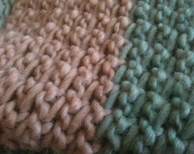 Soft green and oatmeal colored knit wool throw