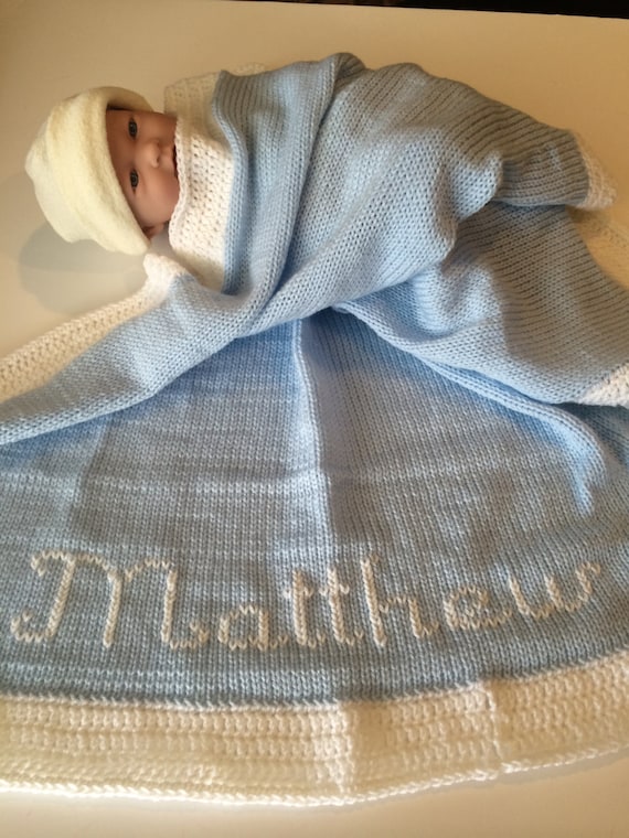 Personalized knitted baby blanket with crocheted border.