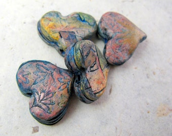 Rough encrusted strata hearts in polymer with turquoise, pink, and blue accents