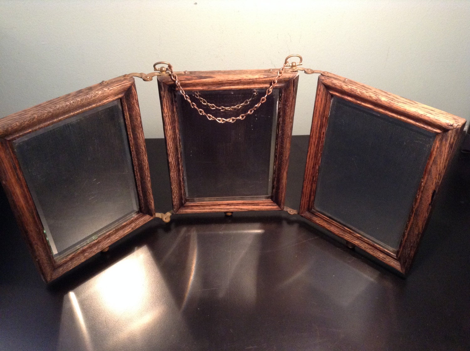 Antique oak trifold shaving mirror with brass hardware and