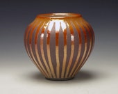 Raku Pottery with striped crackle glaze, orange and brown.