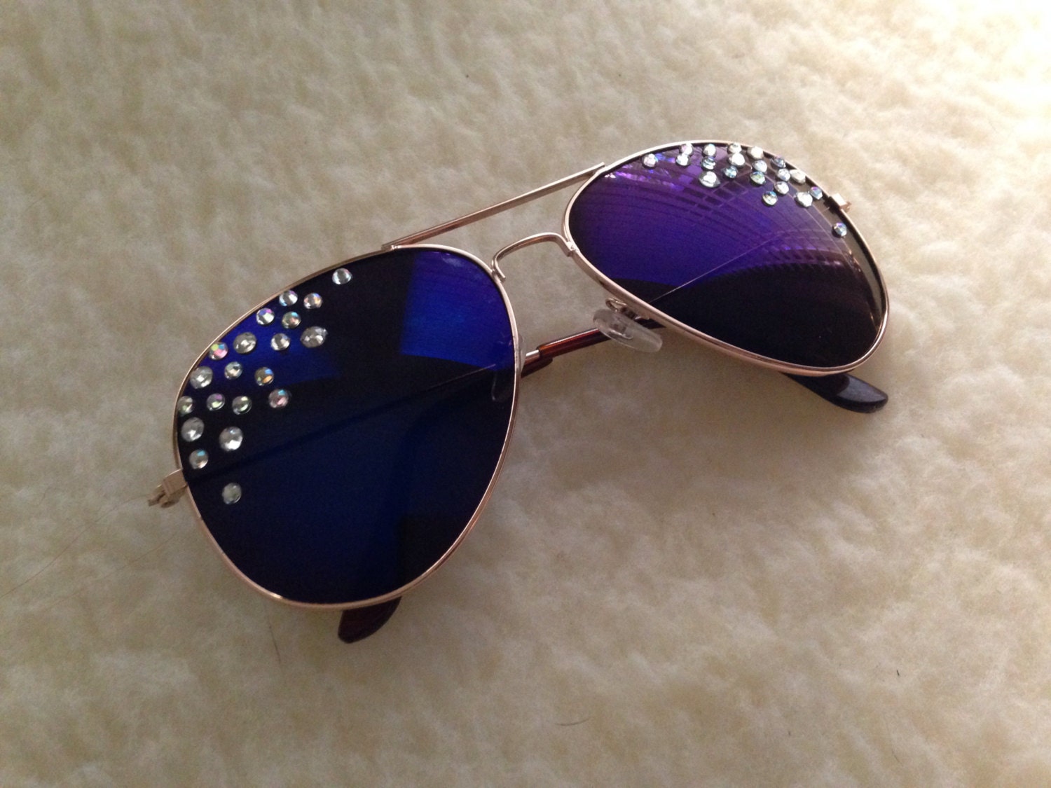 Aviator sunglasses with navy blue lenses and rhinestones