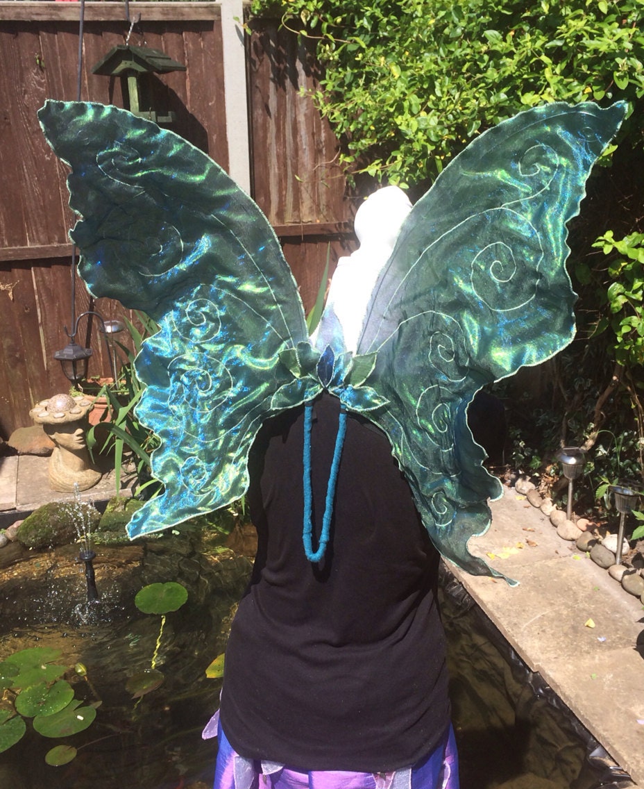 Aqua large butterfly wings with stitched swirls.