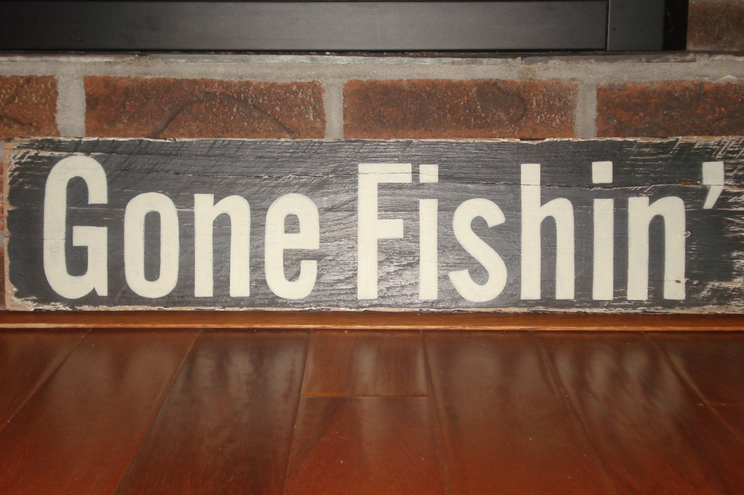Gone Fishin' sign hand painted on very weathered piece of