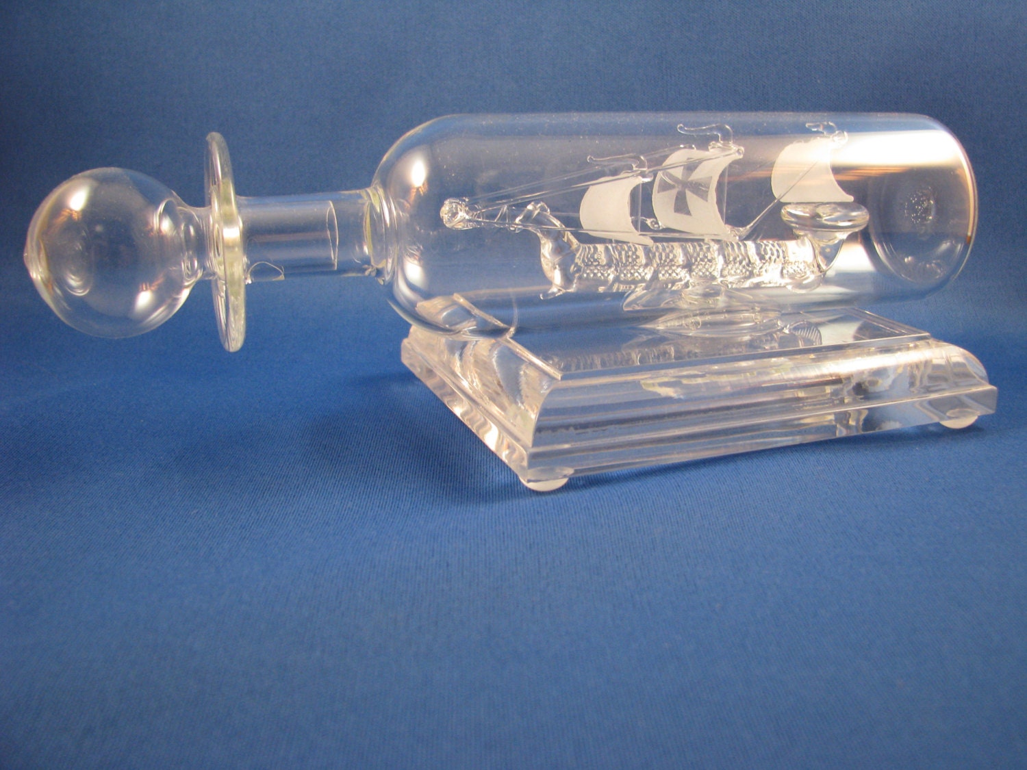 handblown glass ship in a glass bottle hand blown in colorado