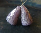 Glimmering Gnome Caps. Polymer clay art beads, faceted iridescent in lilac grey.