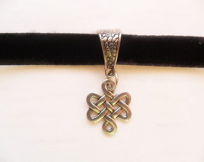 Black velvet choker necklace and celtic knot pendant with a width of 3/8" inch.