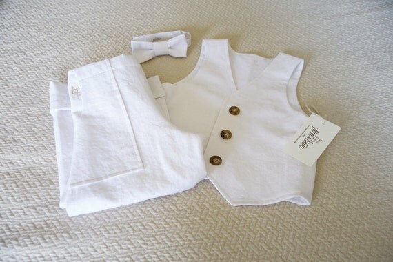 Baby boy white linen suit This smart and timeless white shortie by French designer Tartine et Chocolat, is cool and comfortable to wear. Suitable for both baby boys and girls, it is made in fine linen, and is layered, to give the appearance of a two piece, with pleats around the legs.