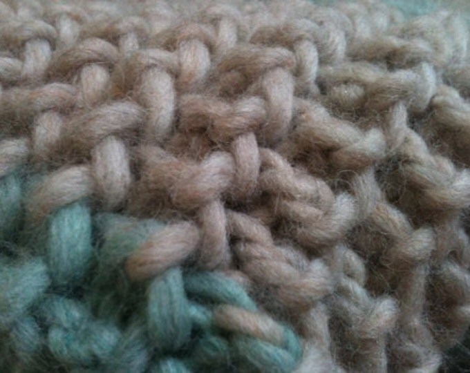 Soft green and oatmeal colored knit wool throw