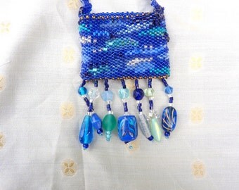Blue ocean inspired amulet bag of glass beads of various styles in ocean wave colors, handmade.