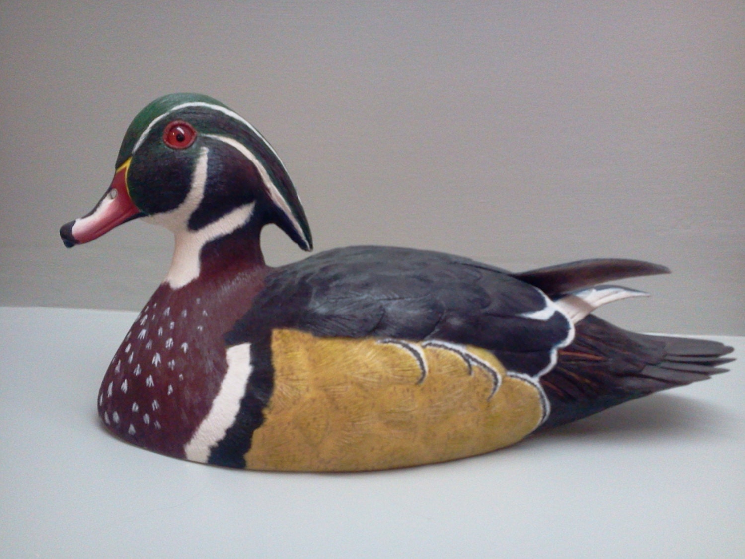 Realistic wood carving of a wood duck decoy.