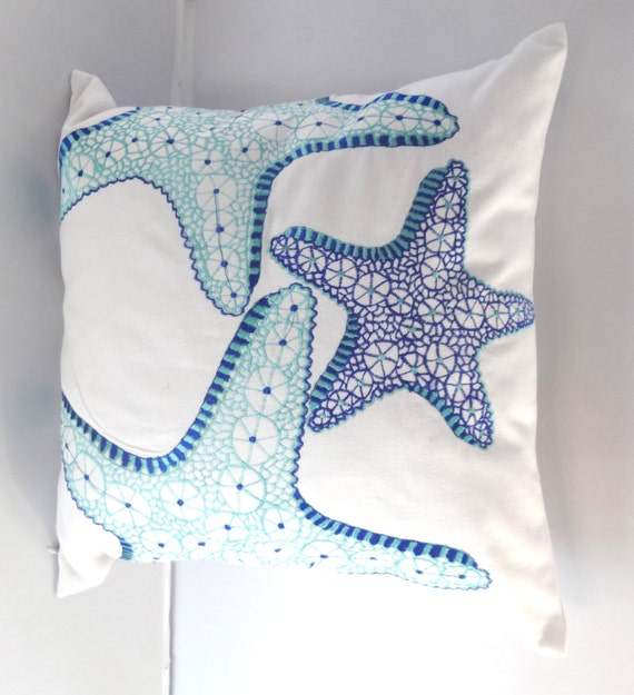 Aqua blue and Cobalt starfish on white pillow. Sea themed