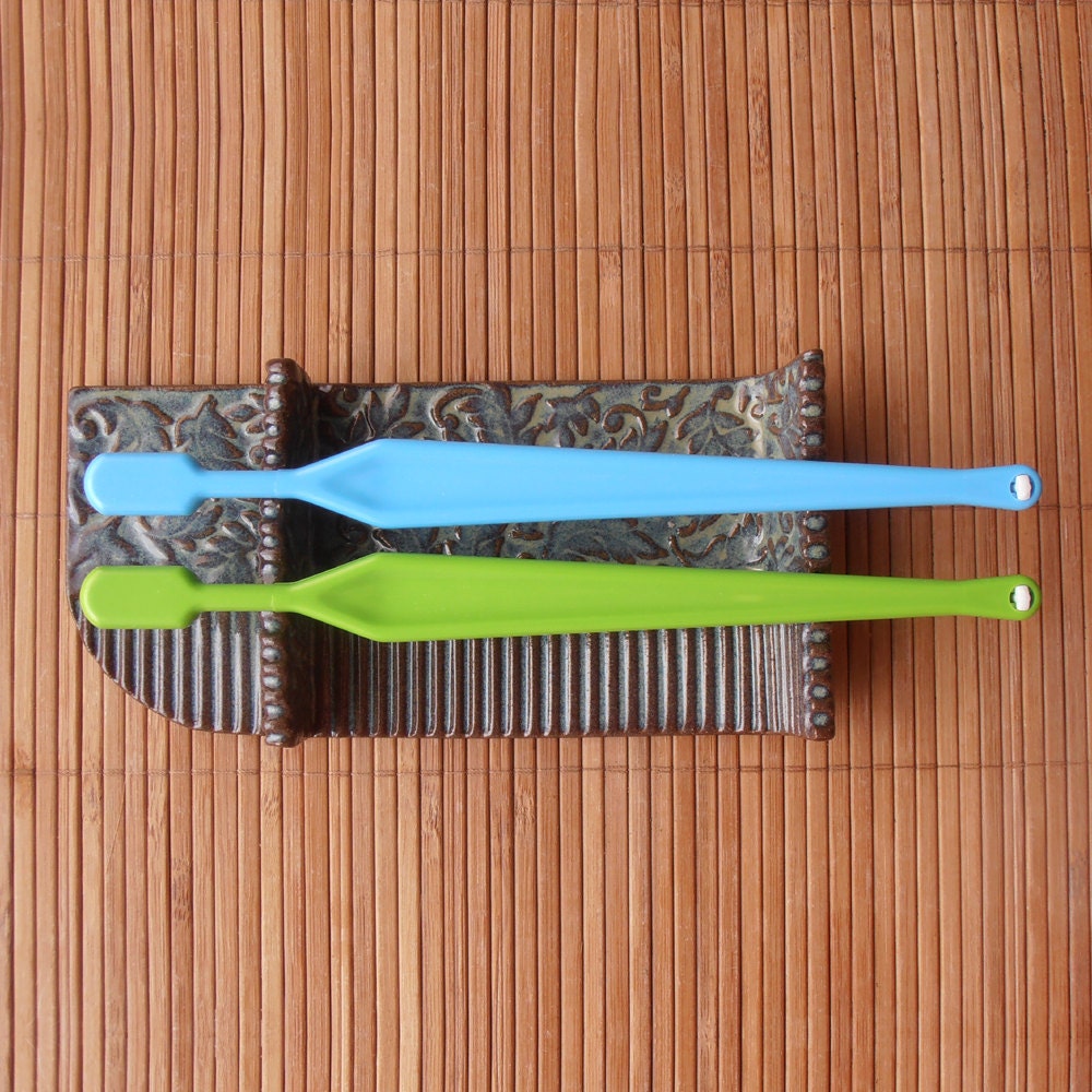 Double ended toothbrushes horizontal holder Blue green color