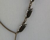 Art Nouveau Asymmetrical necklace, with pearl and dark orange gems.