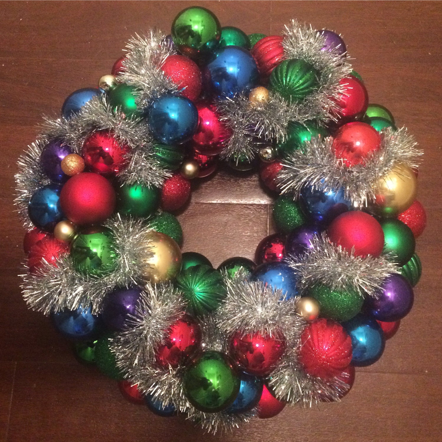 19" Handmade Christmas ornament wreath. Made from a mix of vintage and contemporary ornaments and finished with silver tinsel.