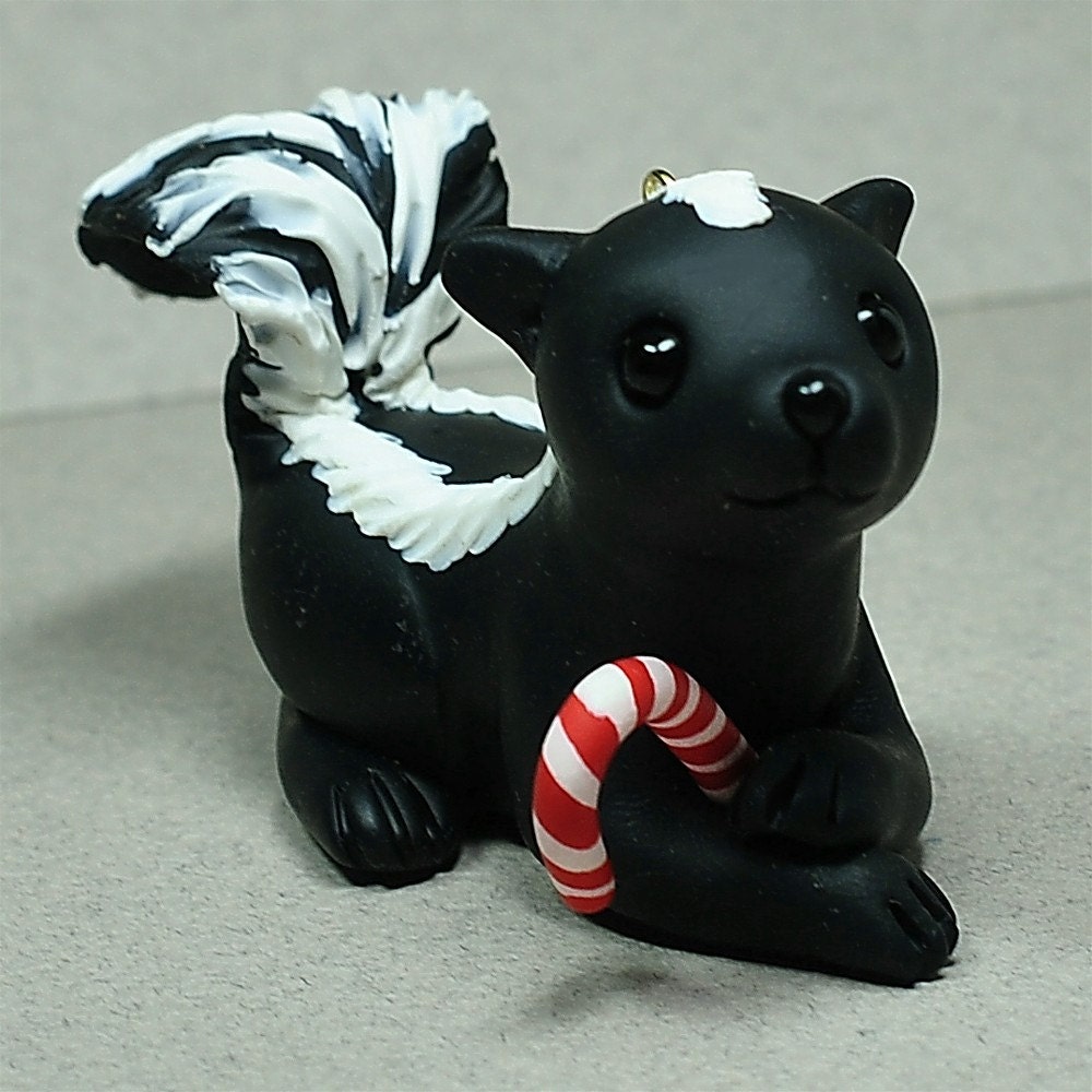 Skunk with a Candy Cane Ornament by Shelly Schwartz