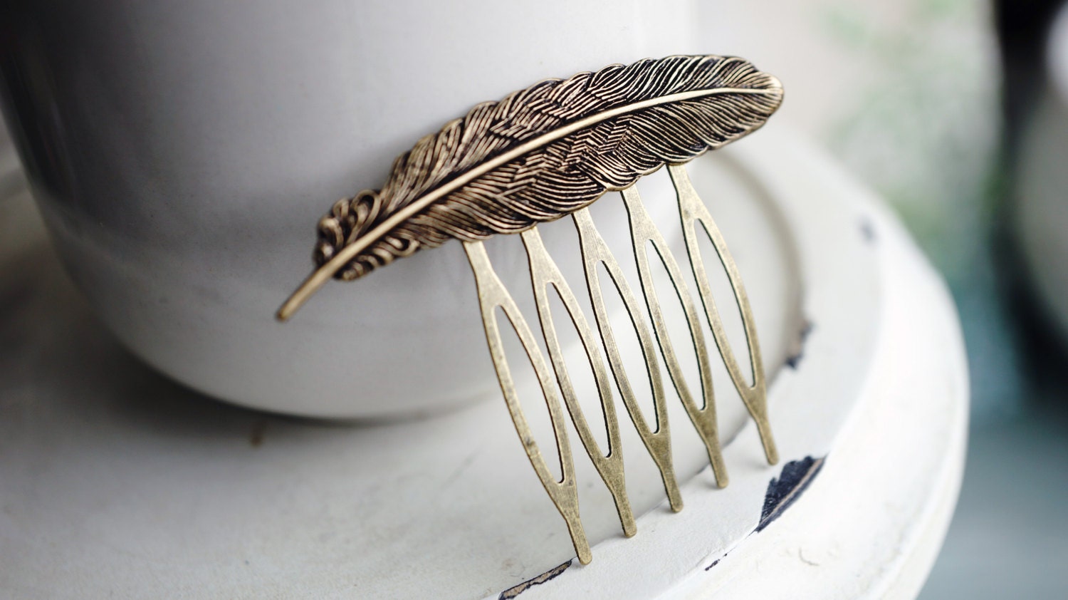 Detailed brass feather hair comb