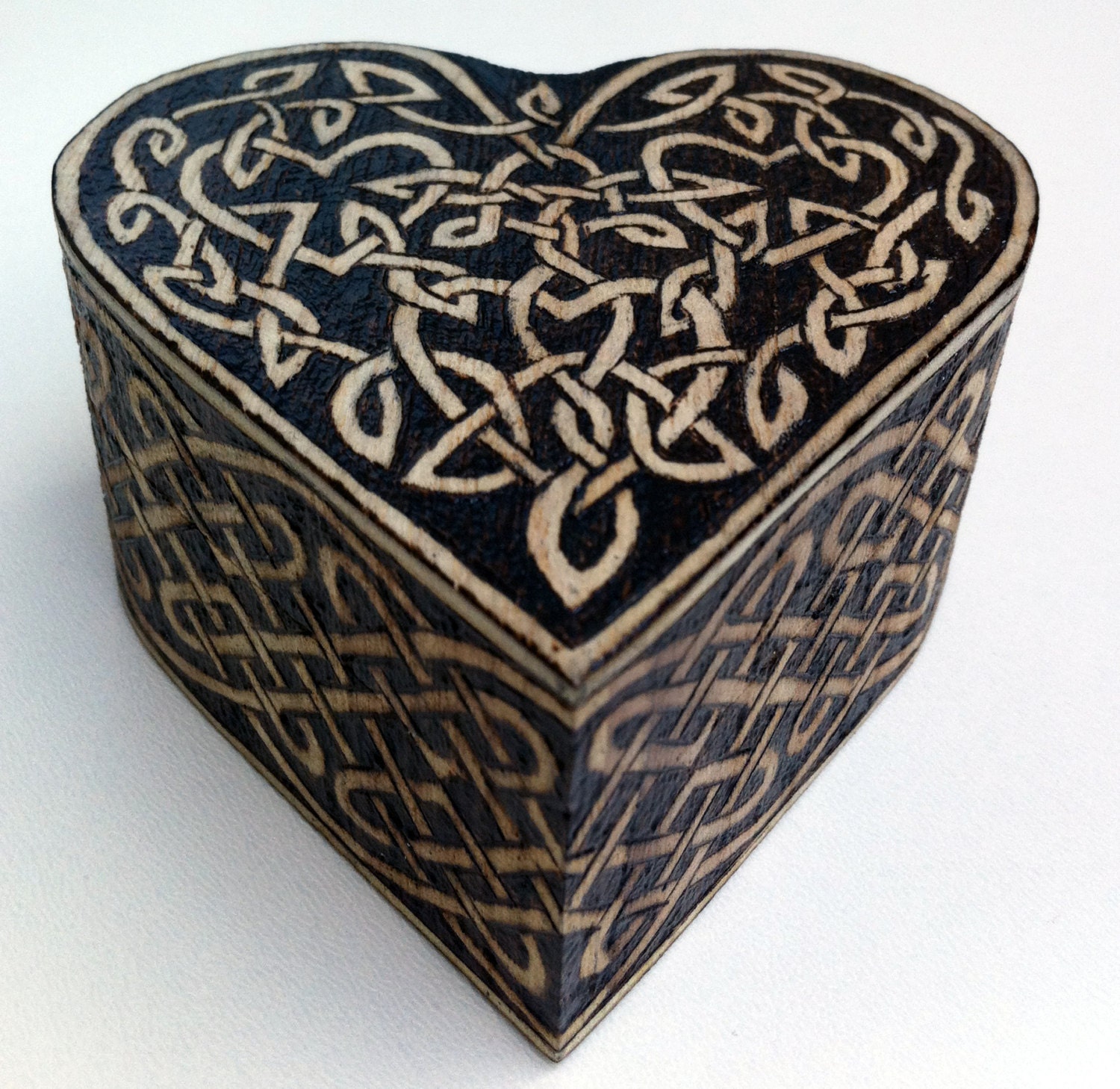 A wood burned jewelry box with beautiful floral design