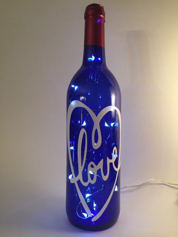 Download Blue lighted wine bottle LED lights. With white lettering Yellowimages Mockups