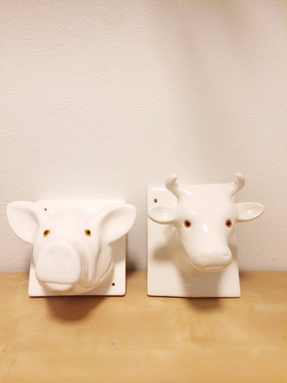 Set of two white ceramic animal bust wall mounts