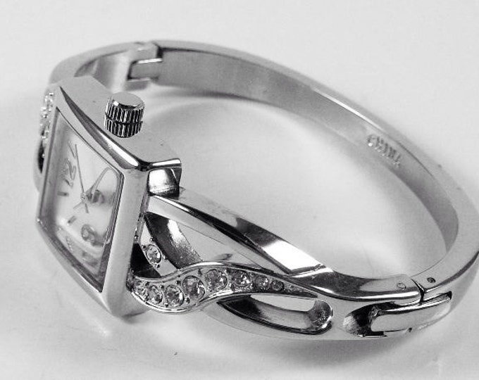 Storewide 25% Off SALE Ladies Silver Tone Diamond Rhinestone Set Designer Quartz Watch Featuring White Bezel And Cuff Bracelet Design