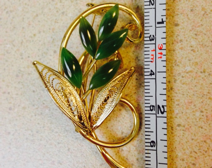 Storewide 25% Off SALE Beautiful vintage 2" goldtone and jade brooch featuring a swirling stem and openwork leaf design with marquis jade st