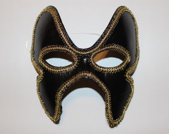 Black butterfly mask with gold trim