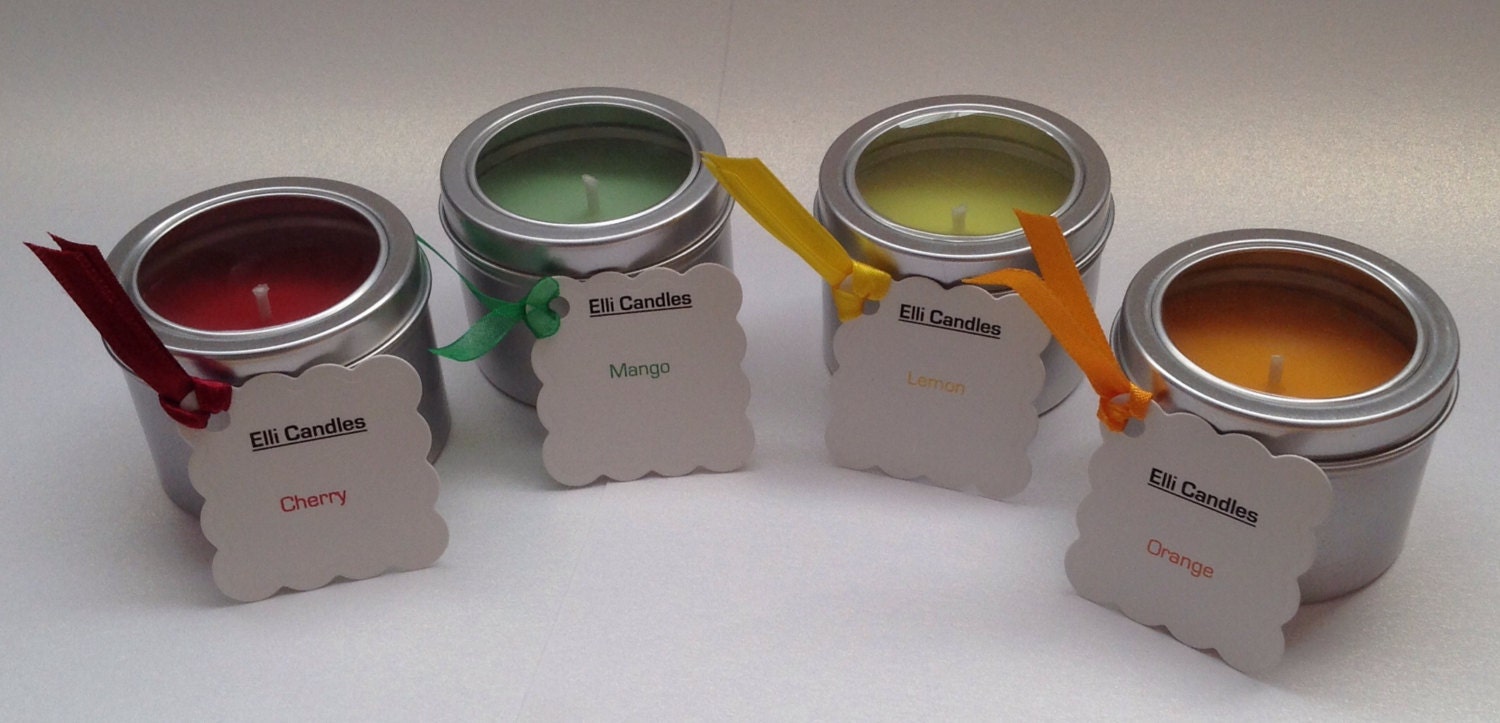 Lovely scented candles in silver tins with clear lids in a