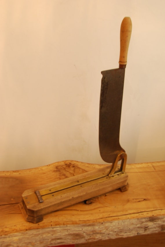 French bread guillotine or bread slicer with wooden base and