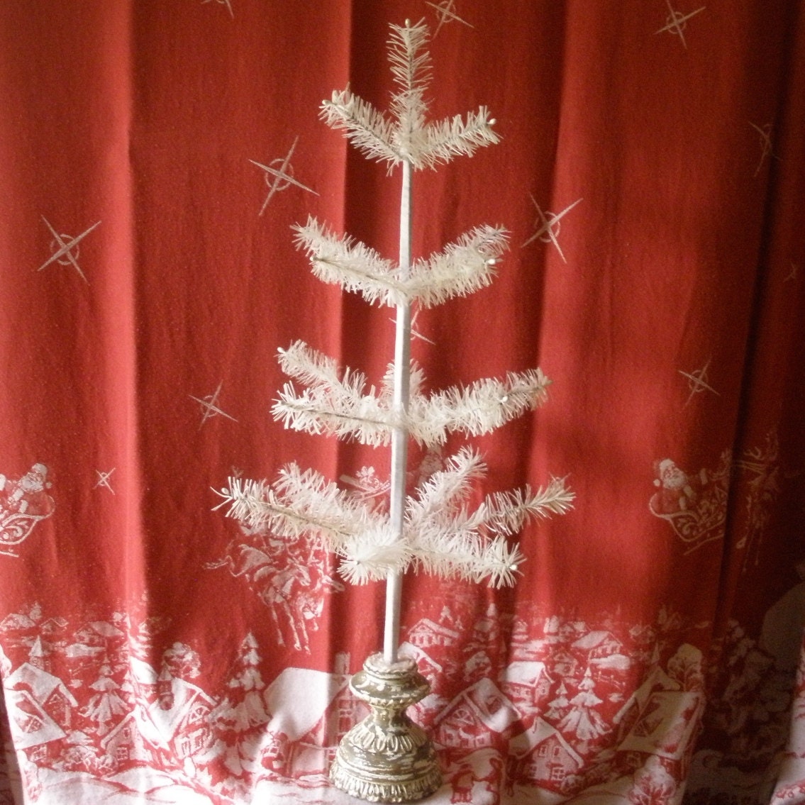 White 19 branch feather tree, 30" tall, 16 " across bottom, it comes in moss, or cedar, all sizes. With or without candles. Candles extra.