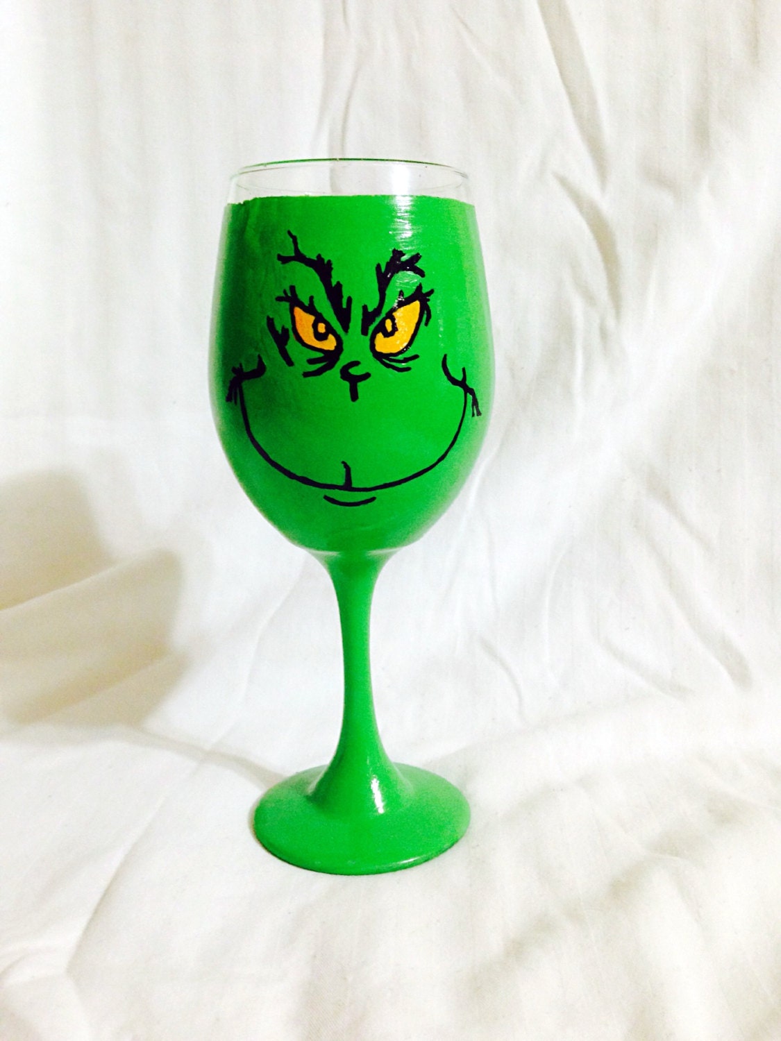 The Grinch inspired hand painted wine glass.
